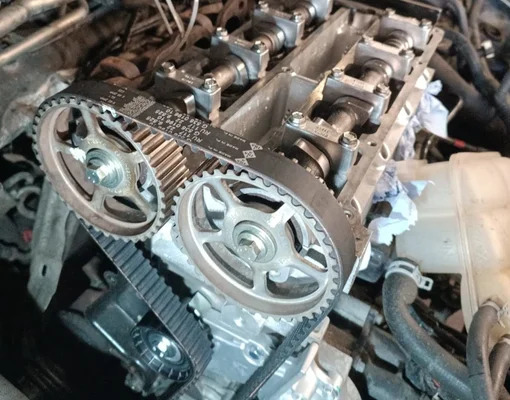 Brand new timing belt and tensioner pulleys installed perfectly on an engine block in the garage